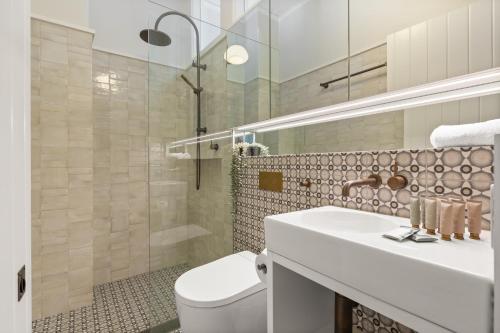 a bathroom with a toilet and a sink and a shower at Quaint 3-Bed Heritage Home in the Heart of Sydney in Sydney