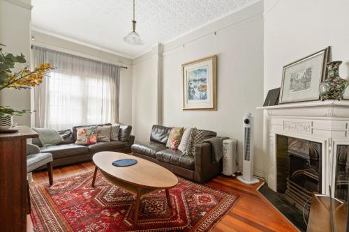 a living room with a couch and a table at Quaint 3-Bed Heritage Home in the Heart of Sydney in Sydney