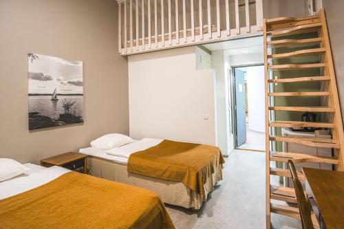 a room with two beds and a ladder at Hyvärilä Youth- and Holiday Centre in Nurmes