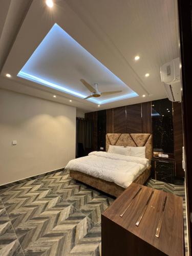 a bedroom with a bed and a ceiling with a skylight at Courteous Hotel in Islamabad