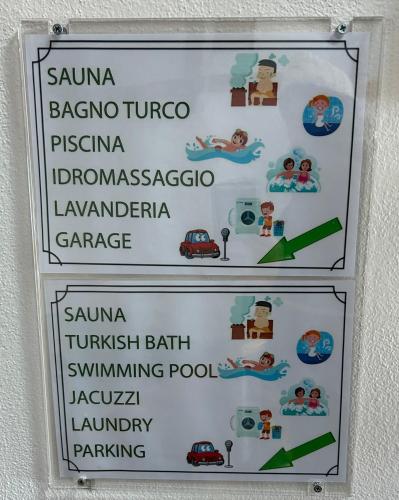 a sign on a wall with a sign for a park at Ploner villaggio Turistico in Dobbiaco