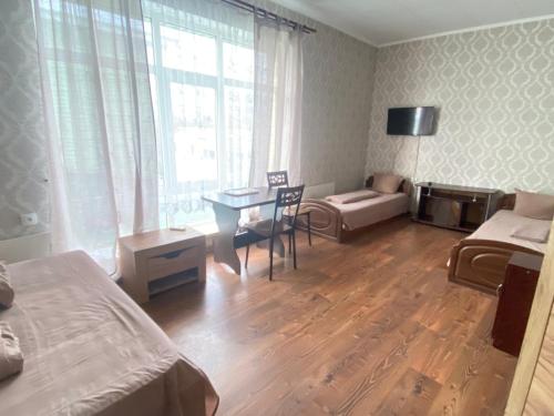a room with a bedroom with a desk and a bed at 4 Seasons in Boryspilʼ