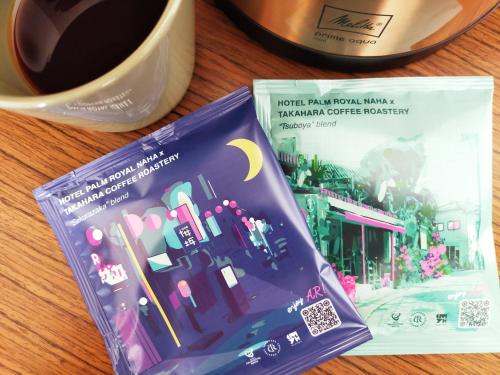 two books on a table next to a cup of coffee at Hotel Palm Royal Resort Kokusai Street in Naha