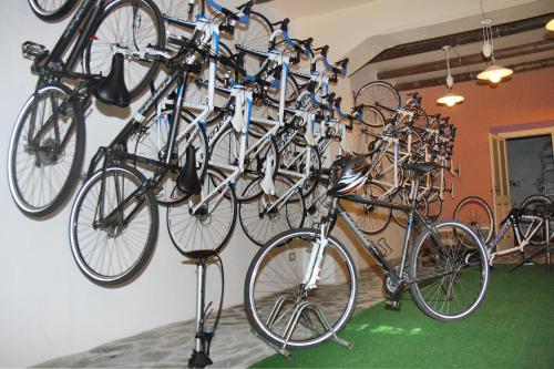a bunch of bikes hanging on a wall at Hotel Villa Gli Asfodeli in Tresnuraghes