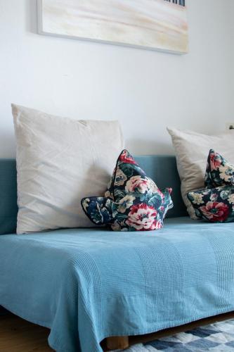 a blue couch with pillows on top of it at Marktlhaus Goldegg in Goldegg