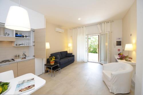 a kitchen and living room with a couch and a table at Residence La Dolce Vita in Maiori