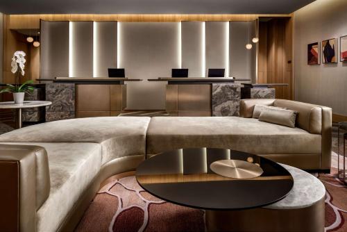 a living room with a couch and a table at Park Hyatt Toronto in Toronto