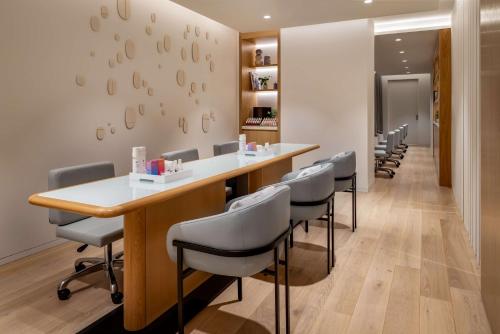 a salon with a long table and chairs at Park Hyatt Toronto in Toronto
