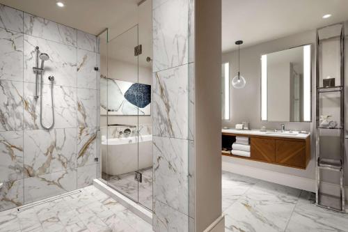 a bathroom with a shower and a sink at Park Hyatt Toronto in Toronto