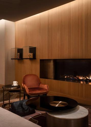 a room with a chair a table and a fireplace at Park Hyatt Toronto in Toronto