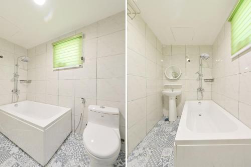 a bathroom with a toilet and a tub and a sink at Mersing Pelangi Beach Resort in Mersing