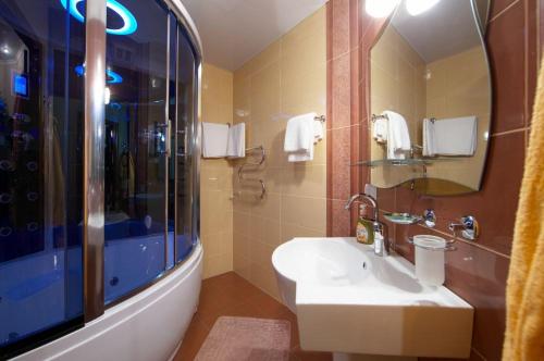 a bathroom with a sink and a shower at Dniprovski Zori in Kremenchuk