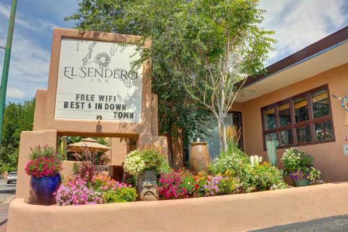 a sign in front of a store with flowers at El Sendero Inn, an Ascend Collection Hotel in Santa Fe