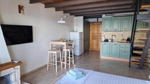 a kitchen with green cabinets and a white refrigerator at Sunrise Studio 2 Afitos in Afitos