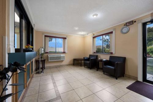 a waiting room with chairs and a table and windows at Econo Lodge Spotsylvania Town Center in Fredericksburg