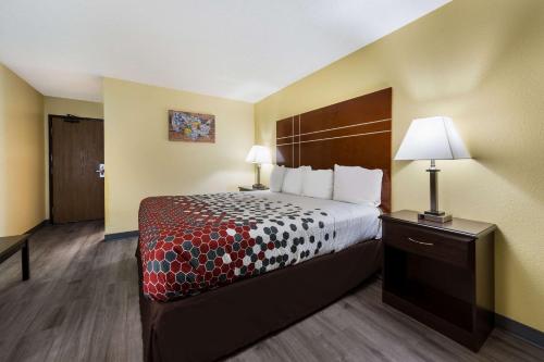 a hotel room with a bed and two lamps at Econo Lodge Spotsylvania Town Center in Fredericksburg