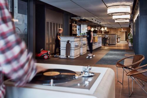 two people standing in a kitchen with a counter at Me and All Hotel Mainz, by Hyatt in Mainz