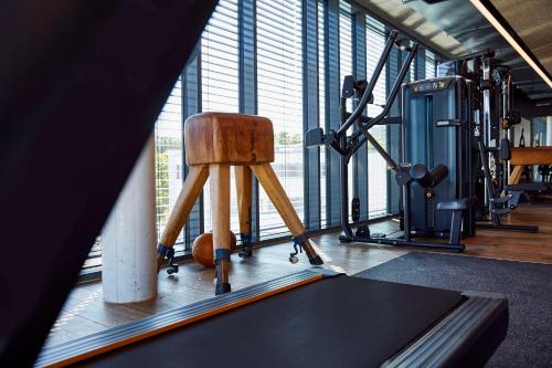 a gym with a chair in the middle of a room at Me and All Hotel Mainz, by Hyatt in Mainz