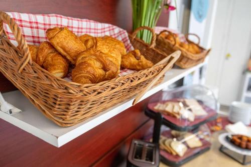a basket of croissants and other pastries on a shelf at Comfort Aparthotel Cannes Mandelieu in Mandelieu-la-Napoule