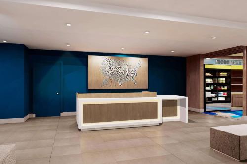 a store with blue walls and a checkout counter at Microtel Inn & Suites by Wyndham Olive Branch in Olive Branch