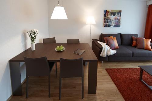 a living room with a table and a couch at CITY STAY - Nordstrasse in Zürich