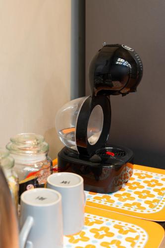 a coffee maker sitting on top of a table with cups at Spacious Homey Pool Villa with Private Parking, Fenced Yard, BBQ, 5min to Beach, Pet-Friendly in Hua Hin