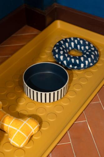 a toy table with two plates and a bowl on it at Spacious Homey Pool Villa with Private Parking, Fenced Yard, BBQ, 5min to Beach, Pet-Friendly in Hua Hin