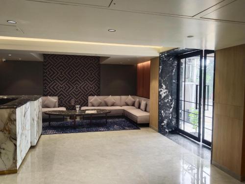 a living room with a couch and a table at Crystal Inn in Agra