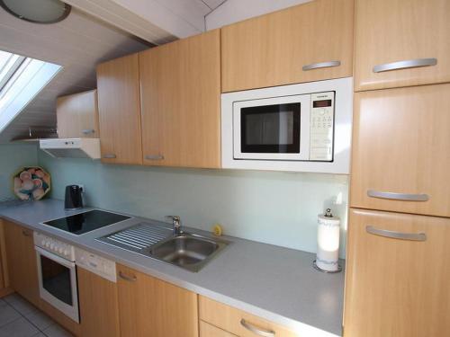 a kitchen with a sink and a microwave at Haus Schallhart in Terfens