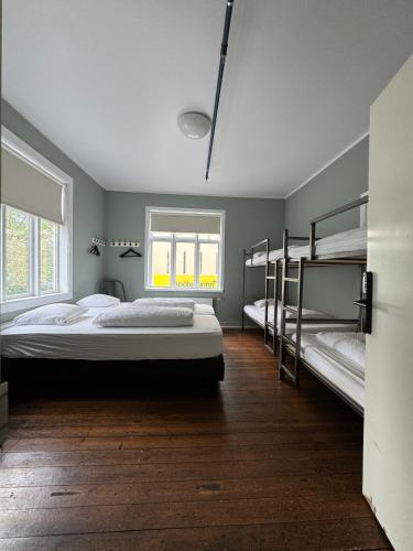 a bedroom with two bunk beds and a window at Akureyri Backpackers in Akureyri