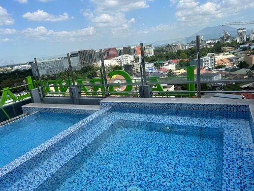 a swimming pool on the roof of a building at 1106 LaGrande2 11floor rooftop swiming angeles Walking street in Angeles