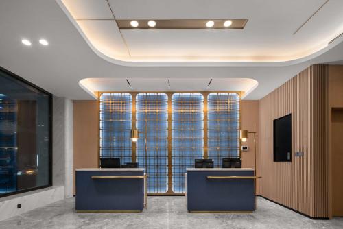 a lobby with two large windows in a building at Holiday Inn Express Harbin Central Avenue by IHG in Harbin