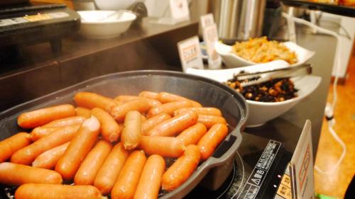 a bunch of carrots in a bowl on a counter at U-Community Hotel in Osaka