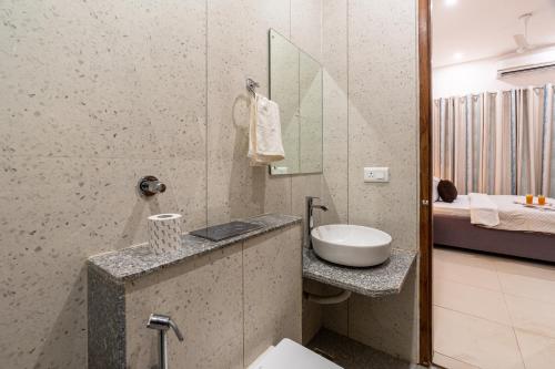 a bathroom with a sink and a toilet in a room at Homlee-Gokul 3BHK Flat-Lift-Parking-vaishali metro in Ghaziabad