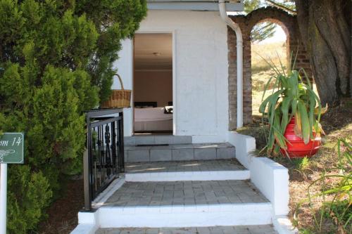 a house with a staircase leading to the front door at mountain shadows hotel in Elliot