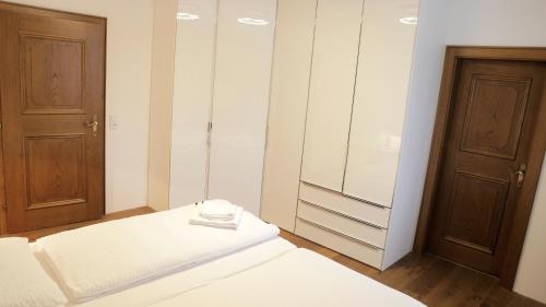 a small room with a bed and a closet at Thurners Dependance in Bruck an der Großglocknerstraße