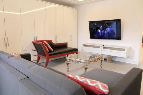 a living room with a couch and a tv at Thurners Dependance in Bruck an der Großglocknerstraße