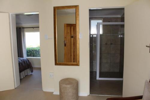 a bathroom with a mirror and a walk in shower at mountain shadows hotel in Elliot
