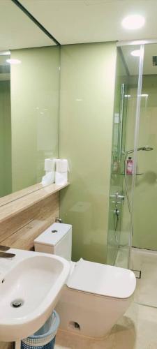 a bathroom with a toilet and a sink and a shower at Sky Suites KLCC by KD Luxury Suites in Kuala Lumpur