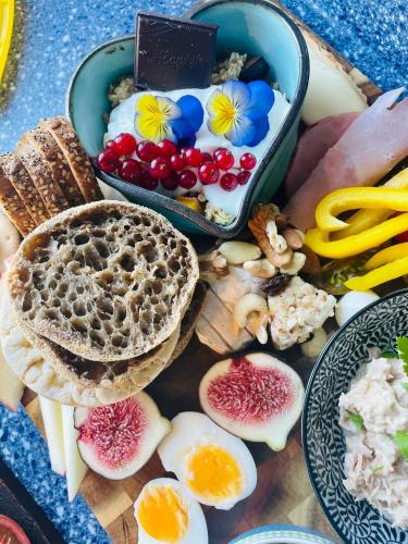 a tray of food with bread and fruits and vegetables at Apartmán U Mluvících Kamenů in Staré Křečany