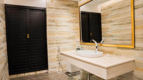 a bathroom with a sink and a mirror at Ramada Resort by Wyndham Gilgit in Gilgit