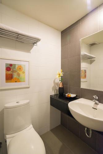 a bathroom with a toilet and a sink at Beyond Suite in Bangkok