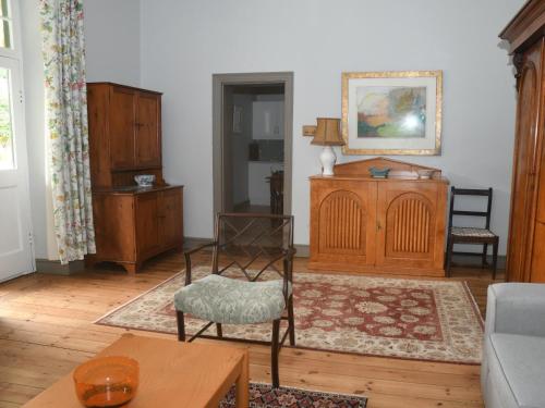 a living room with a chair and wooden furniture at The Old Village in Citrusdal