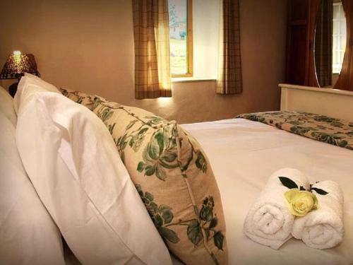 a bedroom with a bed with towels on it at The Old Village in Citrusdal