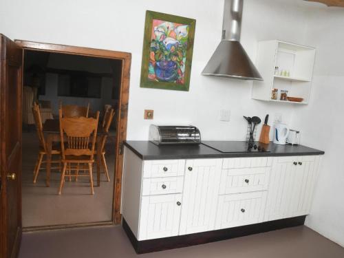 a kitchen with a counter and a dining room at The Old Village in Citrusdal