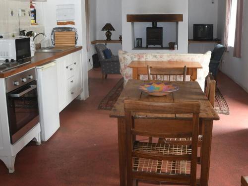 a kitchen and living room with a table and chairs at The Old Village in Citrusdal