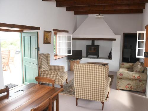 a living room with a table and chairs at The Old Village in Citrusdal