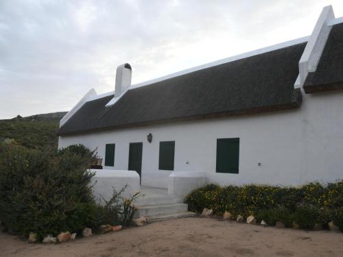 a white building with a black roof at The Old Village in Citrusdal