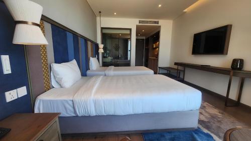 Ένα ή περισσότερα κρεβάτια σε δωμάτιο στο Apec Wyndham Luxe Escape Mui Ne