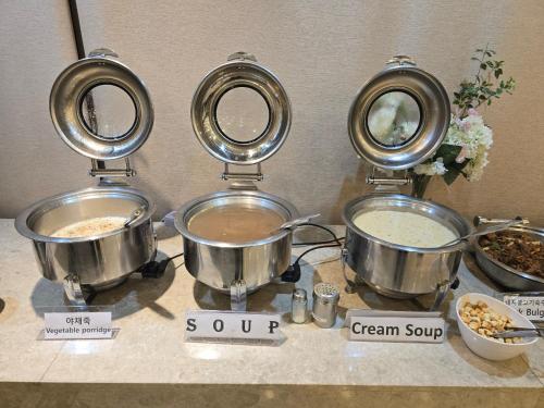a group of pots and pans on a counter at The Recenz Dongdaemun Hotel in Seoul
